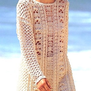 May include: A white crocheted top with a long sleeve and a loose fit. The top features a delicate floral pattern and is ideal for a summer day.