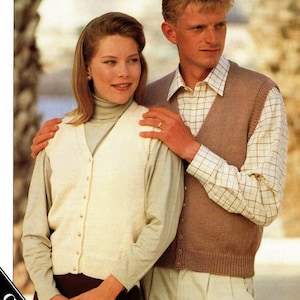 May include: A couple wearing knitted vests. The woman wears a cream-colored button-down cardigan over a turtleneck. The man wears a brown vest over a plaid shirt. The image has text at the top that reads "4 PLY DK ARAN CHUNKY".