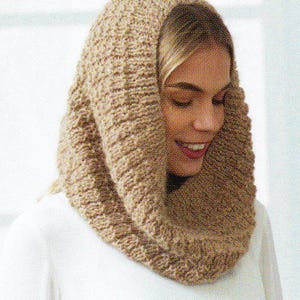 May include: A tan-colored, knitted cowl scarf. The scarf is made of a thick, textured yarn and is draped around the neck and head. The cowl is a neutral color, suitable for various outfits and seasons.