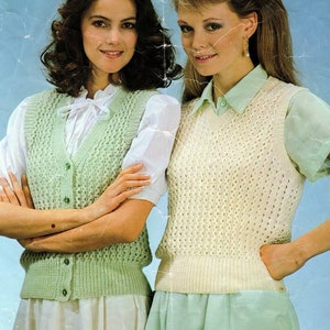 May include: Two women wearing sleeveless knitted vests. The vest on the left is light green and the vest on the right is white.
