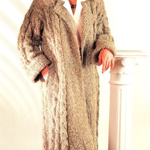 May include: A long, beige knitted cardigan with a cable knit pattern. The cardigan has a collar and a front opening. The text "Easy knit" is visible in the top right corner of the image.