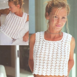 May include: White crochet sleeveless top with a delicate floral pattern. The top has a scoop neckline and a cropped length.
