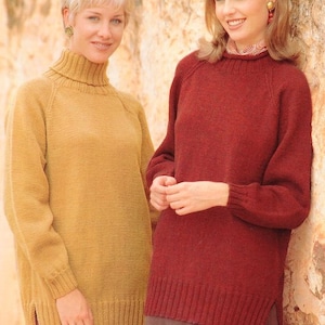 May include: Two women wearing jumpers. The woman on the left is wearing a yellow turtleneck jumper. The woman on the right is wearing a red jumper with a round neckline.