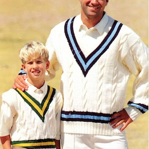 May include: Two people wearing white knitted sweaters with blue and green stripes. The person on the left is wearing a vest with a V-neck and the person on the right is wearing a sweater with a V-neck.