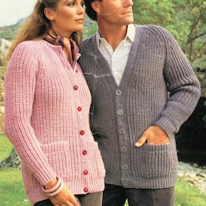 May include: Two knitted cardigans, one pink and one grey, with button fastenings and pockets. The cardigans are made with a textured stitch.