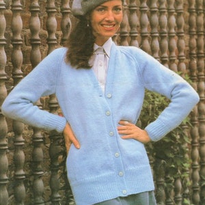 May include: A light blue knitted cardigan with a V-neck and button closure. The cardigan is long-sleeved and has a ribbed hem and cuffs.