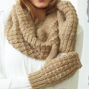 May include: A tan-colored knitted scarf and matching mittens set. The scarf is a loop style, and the mittens are fingerless. The knitwear has a textured pattern, perfect for cold weather. The set is made of a soft, warm material.