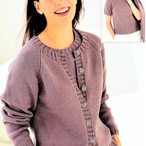 May include: A purple knitted cardigan with a button-up front and long sleeves. The cardigan has a ribbed collar and cuffs.