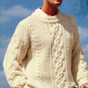 May include: A white cable knit sweater with a crew neck. The sweater has a textured pattern and is made of a soft, warm material.