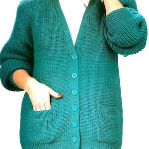 Peut inclure: Un cardigan en tricot bleu sarcelle avec un col en V, des manches longues et une fermeture à boutons. Le cardigan a deux poches plaquées sur le devant.