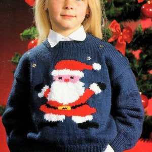 May include: A blue knitted sweater with a white, red, and black Santa Claus design. The sweater has a white collar and is decorated with silver snowflakes.