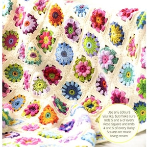 May include: A crocheted blanket with a floral pattern in various colors. The blanket is made with a cream-colored yarn and features colorful flowers in shades of pink, red, blue, green, and yellow. The text on the image reads: "Use any colours you like, but make sure rnds 5 and 6 of every Rose Square and rnds 4 and 5 of every Daisy Square are made using cream."
