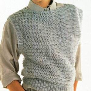 May include: A light blue knitted vest with a loose, open weave pattern. The vest is sleeveless and has a round neckline.