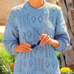 May include: A light blue knitted sweater with a diamond pattern and openwork design. The sweater has long sleeves and a crew neckline.