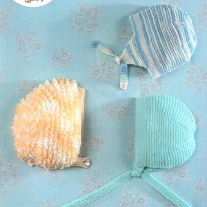 May include: Three knitted baby hats in different colors and styles. One hat is a light blue and white striped hat with a tie. Another hat is a light green hat with a tie. The third hat is a fluffy, cream and yellow hat.