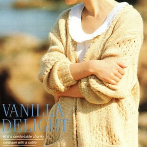 May include: A close-up of a woman wearing a beige knitted cardigan with a cable pattern. The cardigan has pockets and a V-neck. The text "VANILLA DELIGHT" is visible in the image. The text below the title reads "Knit a comfortable chunky cardigan with a cable running into a textured triangle. In a pure wool yarn, it would be really special."