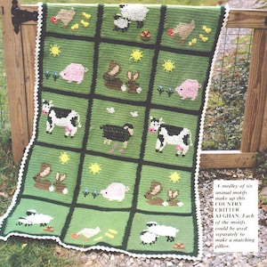 May include: A green crochet blanket with a white border features a variety of animal motifs, including cows, pigs, chickens, sheep, rabbits, and a black bird. The blanket is made up of six different squares, each featuring a different animal. "A medley of six animal motifs make up this COUNTRY CRITTER AFGHAN. Each of the motifs could be used separately to make a matching pillow."