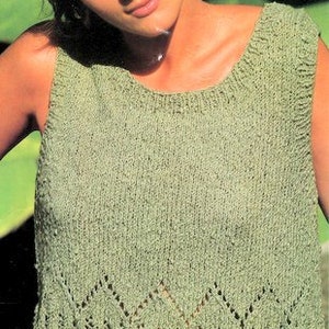 May include: A green sleeveless knitted top with a diamond-shaped lace pattern at the bottom.