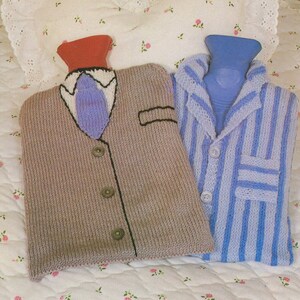 May include: Two knitted hot water bottle covers. One is a brown sweater with a blue tie and the other is a blue and white striped pajama top.
