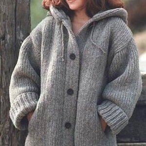 May include: A gray knitted hooded cardigan with a button closure. The cardigan has pockets on the sides and a ribbed hem.