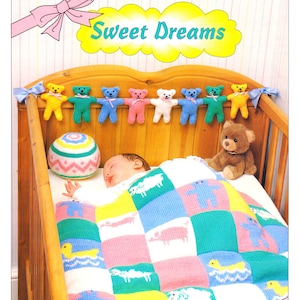 May include: A knitted baby blanket with a patchwork design featuring various animals, including bears, lambs, and ducks. The blanket is in shades of pink, blue, green, and yellow. A baby is sleeping in a crib with the blanket, and there is a knitted teddy bear toy and a knitted ball hanging above the crib.