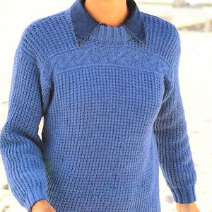 May include: A blue knitted jumper with a ribbed texture and a round neckline. The jumper has a denim collar.