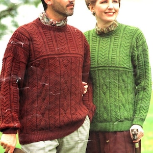 May include: Two knitted sweaters, one in a deep red color and the other in a bright green color. Both sweaters feature a cable knit pattern with a chevron design.