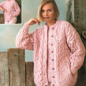May include: A pink knitted cardigan with a cable knit pattern and button closure. The cardigan has a textured surface with small bobbles throughout.