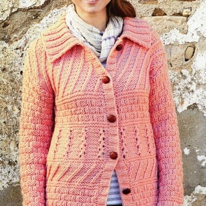 May include: A pink knitted cardigan with a button-up front and a textured pattern. The cardigan has a wide collar and long sleeves.