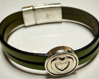 May include: Olive green leather bracelet with a silver-tone magnetic clasp and a decorative silver-tone heart charm. The bracelet features two bands of olive green leather. The heart charm has a layered heart design.
