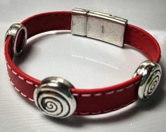 May include: Red leather bracelet with a silver magnetic clasp and three silver spiral-shaped beads.