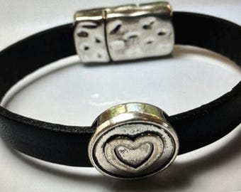 May include: A black leather bracelet with a silver heart charm and a silver magnetic clasp.