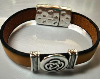 May include: A brown leather bracelet with a silver magnetic clasp and a silver Celtic knot design.