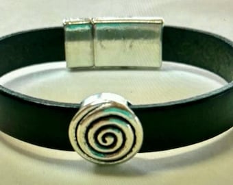 May include: A black leather bracelet with a silver magnetic clasp and a silver spiral charm.