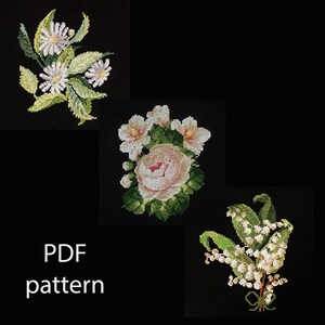 May include: Cross-stitch floral patterns on a black background. The image features three floral designs: daisies, a pink rose, and lily of the valley. The text "PDF pattern" is displayed in white.