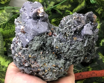 May include: A cluster of gray, black, and gold crystals. The crystals are arranged in a rough, natural formation.