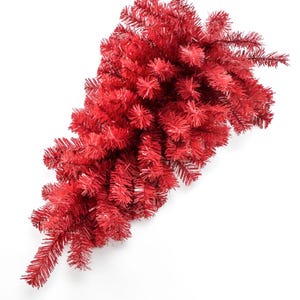 May include: A red artificial Christmas tree garland with a cascading design. The garland is made of plastic and has a realistic look.