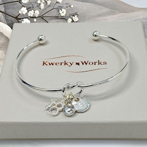 18th birthday gift bracelet for women. Adjustable silver-plated friendship knot bracelet with silver plated 18 charm, initial letter charm and choice of birthstone crystal colour to suit the birth month