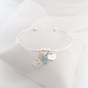 21st birthday gift bracelet for women. Adjustable silver-plated friendship knot bracelet with silver plated 21 charm, initial letter charm and choice of birthstone crystal colour to suit the birth month