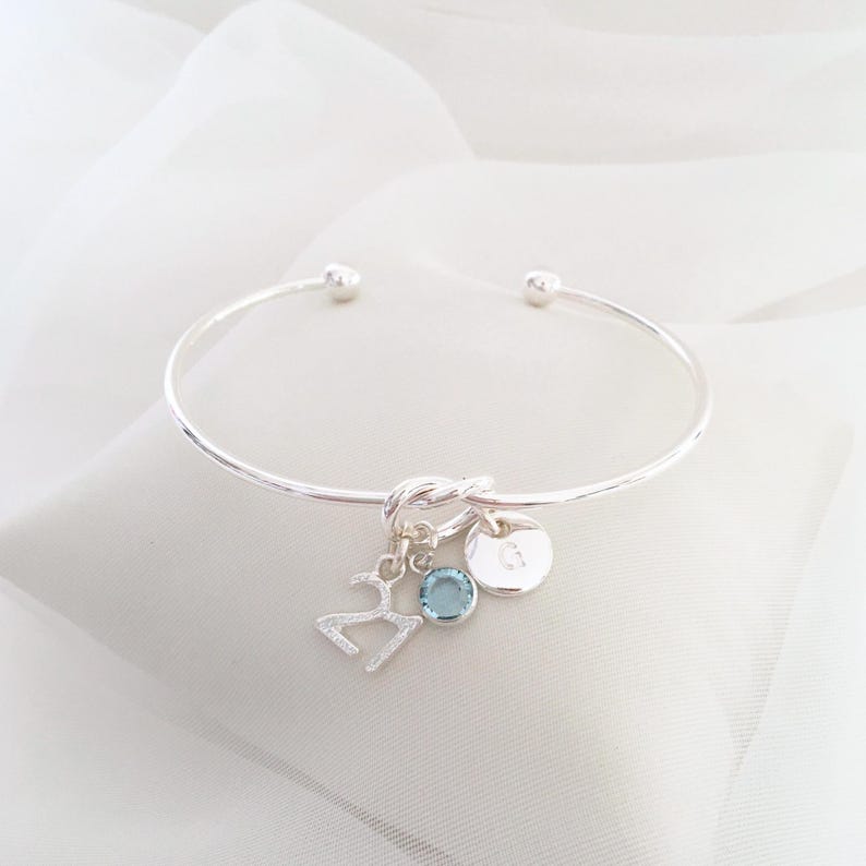 21st birthday gift bracelet for women. Adjustable silver-plated friendship knot bracelet with silver plated 21 charm, initial letter charm and choice of birthstone crystal colour to suit the birth month
