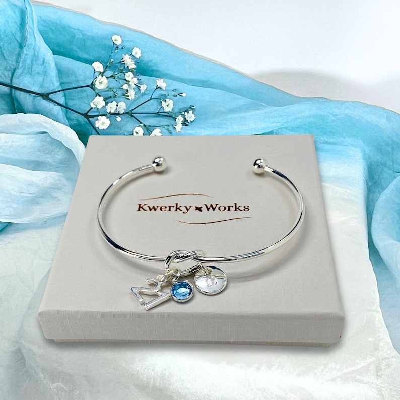 21st birthday gift bracelet for women. Adjustable silver-plated friendship knot bracelet with silver plated 21 charm, initial letter charm and choice of birthstone crystal colour to suit the birth month