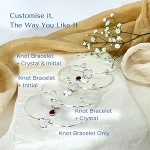Personalised Silver Knot Bracelet with Initial and Birthstone Crystal - image shows all the options that you can select - knot bangle on its own, or with the addition of 1 crystal or 1 initial or both a crystal and an initial charm.