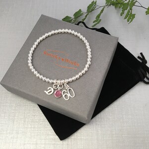 This bracelet is presented in a black velveteen drawstring pouch, inside an attractive eco-friendly grey card gift box.