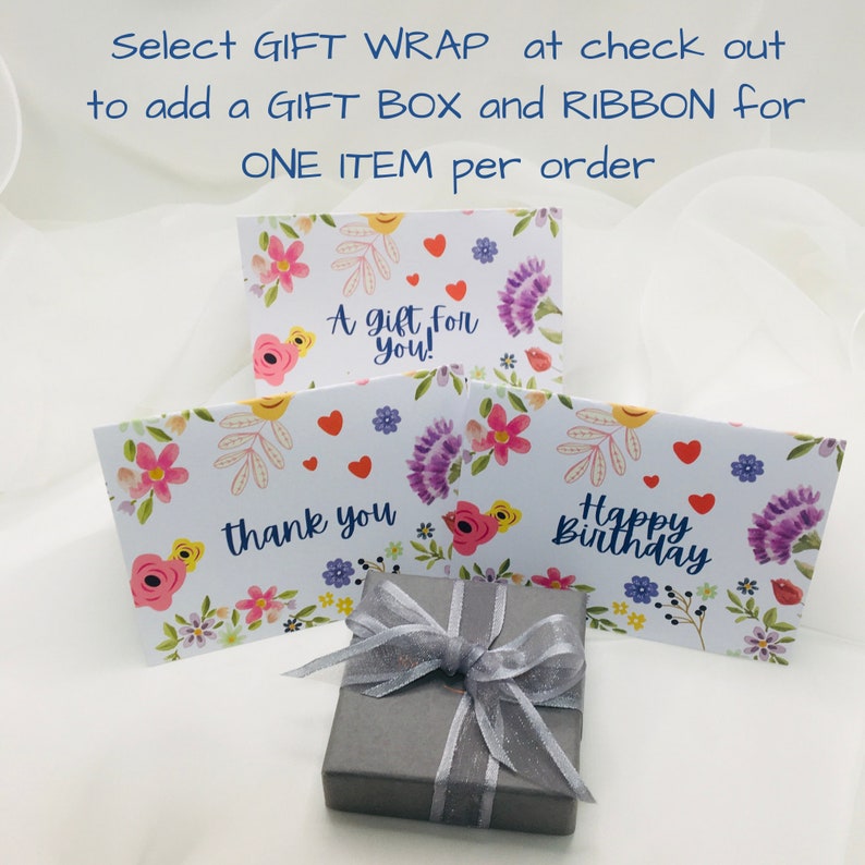 Select Gift Wrap at checkout to add a pretty 
 ribbon- tied gift box to your order. Additional costs apply. The gift box is a grey card jewellery box tied with a grey organza and satin ribbon. The box is made from a FSC certified paper source.