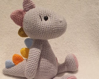 Rosie baby dinosaur in grey with multi-coloured spikes. Quality handmade crochet soft toy.