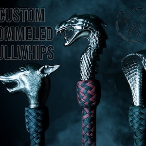 May include: Three custom pommeled bullwhips with animal head designs. The heads are silver-colored and include a wolf, a dragon, and a cobra. The handles are intricately woven in black, red, and green. The text "CUSTOM POMMELED BULLWHIPS" is at the top.
