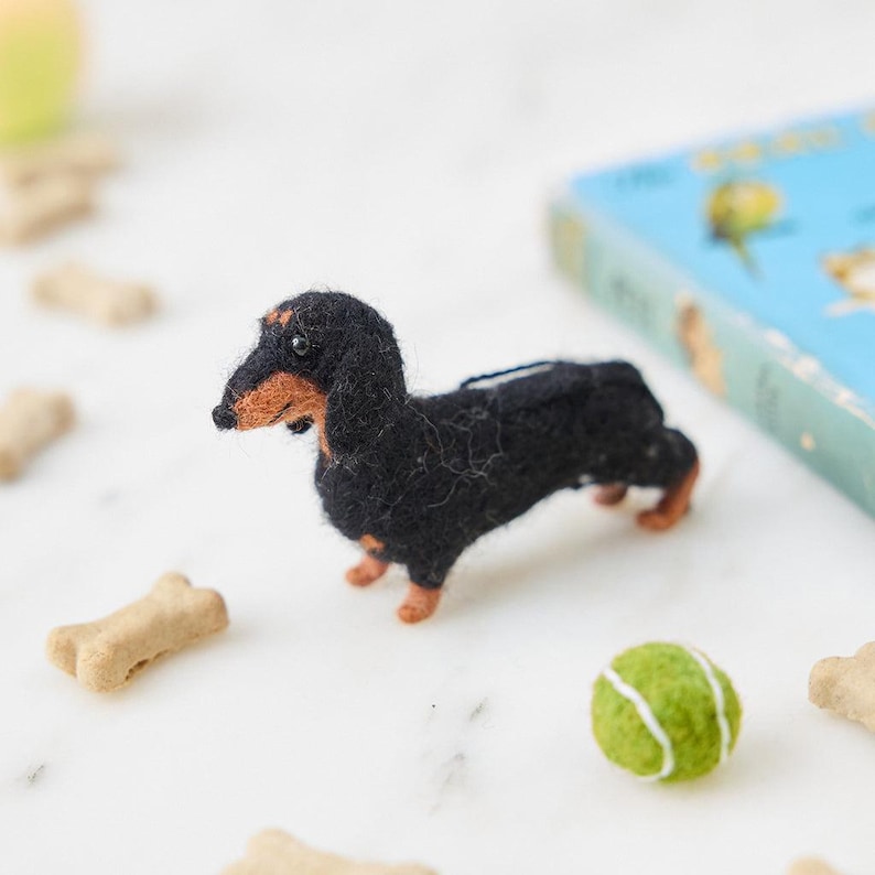 Handmade felt dachshund ornament in black and brown with long-body details, a cute dog decoration perfect for dachshund and small-pet lovers.