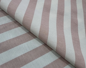 May include: Close-up of a fabric with alternating wide stripes in dusty rose and white. The fabric is folded over, showing the texture and pattern of the material. The stripes run diagonally across the image.