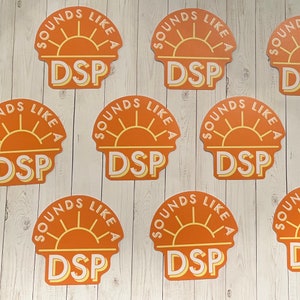 May include: Nine orange and yellow stickers with the text "Sounds Like A DSP" in white letters. The stickers feature a stylized sun with rays.