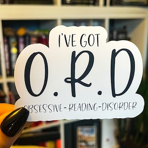 May include: White sticker with black text that reads "I've got O.R.D. Obsessive-Reading-Disorder".